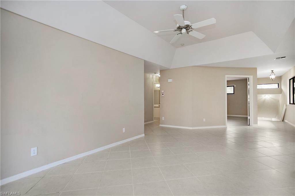 191 Bennington Drive, Unit 124 Naples, FL 34104 - Photo 10 of 26 wooden floor in an empty room with a window