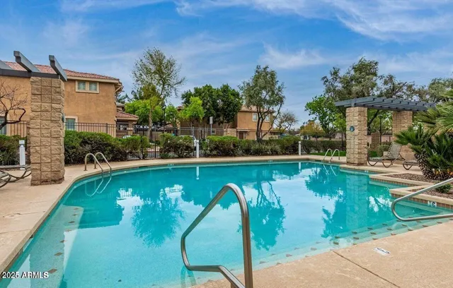 a view of a swimming pool with outdoor seating