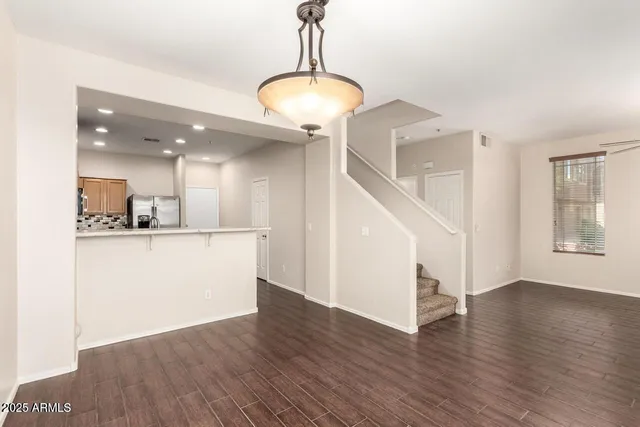 a view of a kitchen with wooden floor and a kitchen