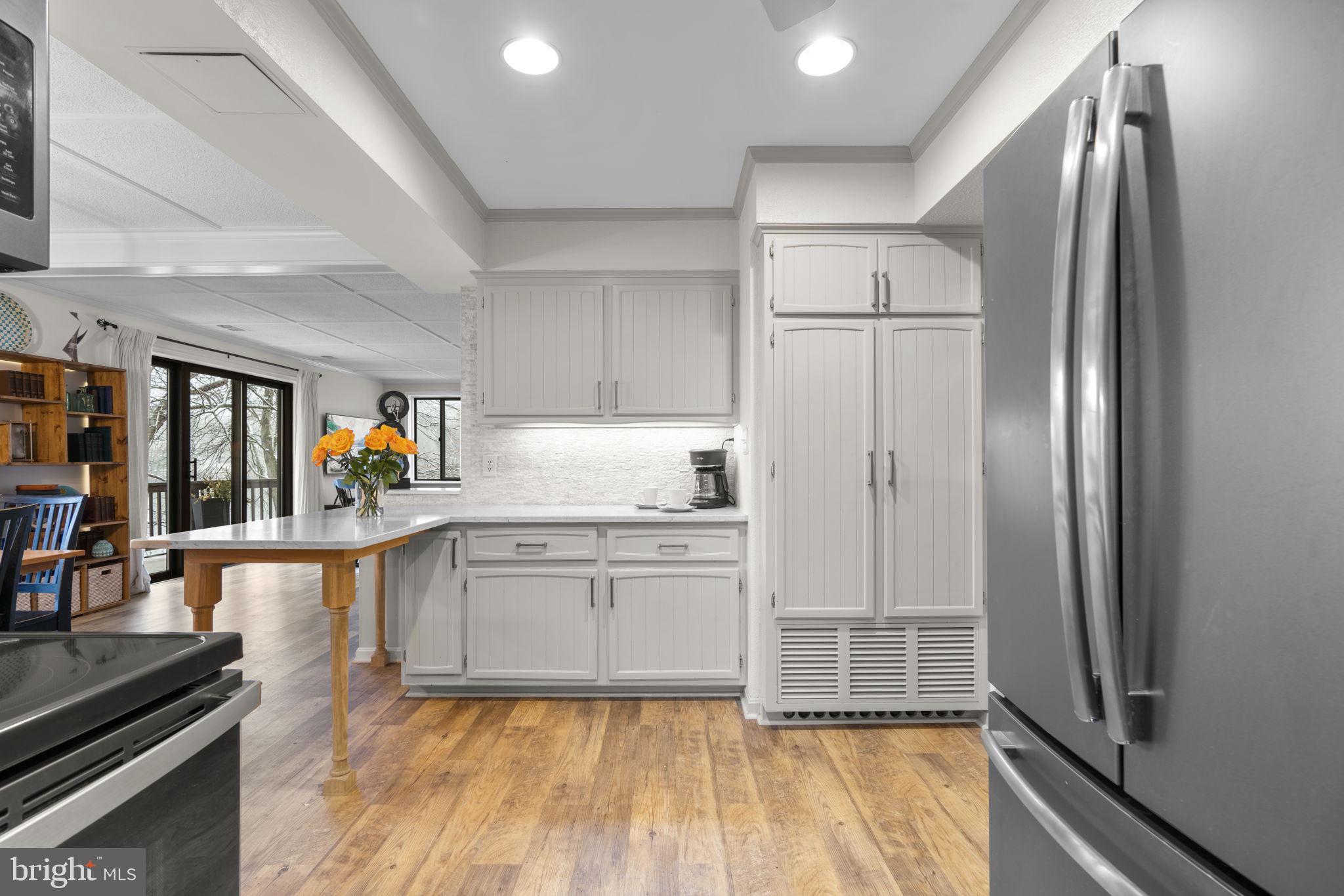 10077 Windstream Drive, Unit 4 Columbia, MD 21044 - Photo 11 of 59 Kitchen opens to the dining and living room areas