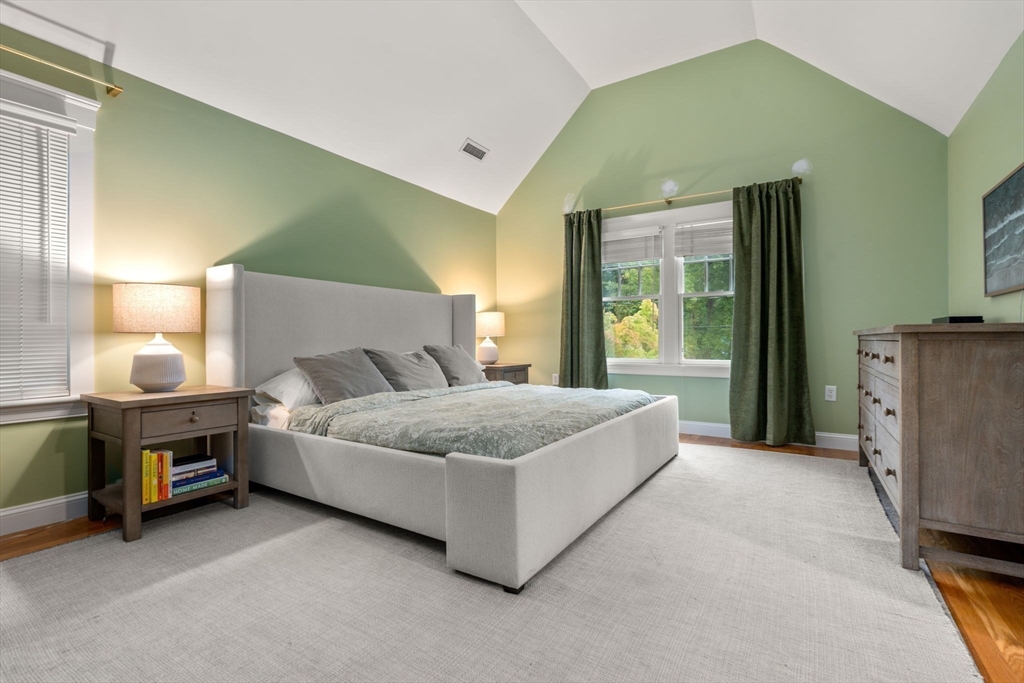4 Strathmore Road Wellesley, MA 02482 - Photo 20 of 36 a spacious bedroom with a bed lamp and a mirror