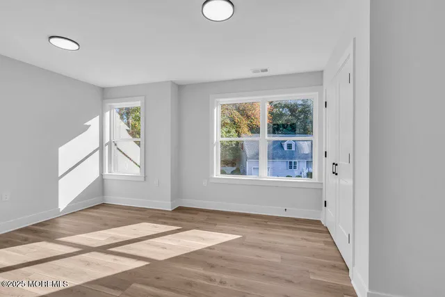 a view of a room with wooden floor
