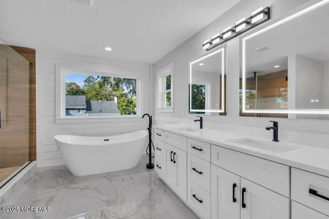 a bathroom with a bathtub and a shower