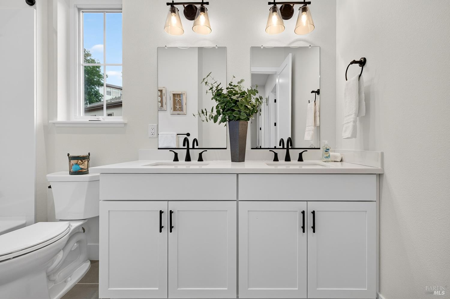 1925 Carlile Place Santa Rosa, CA 95403 - Photo 44 of 70 Here is the hall bathroom with dual sink vanity, dual mirrors and quartz countertop.