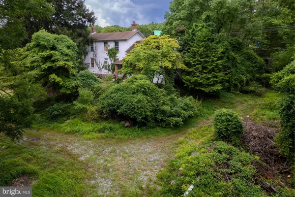 an aerial view of a house with a yard and garden