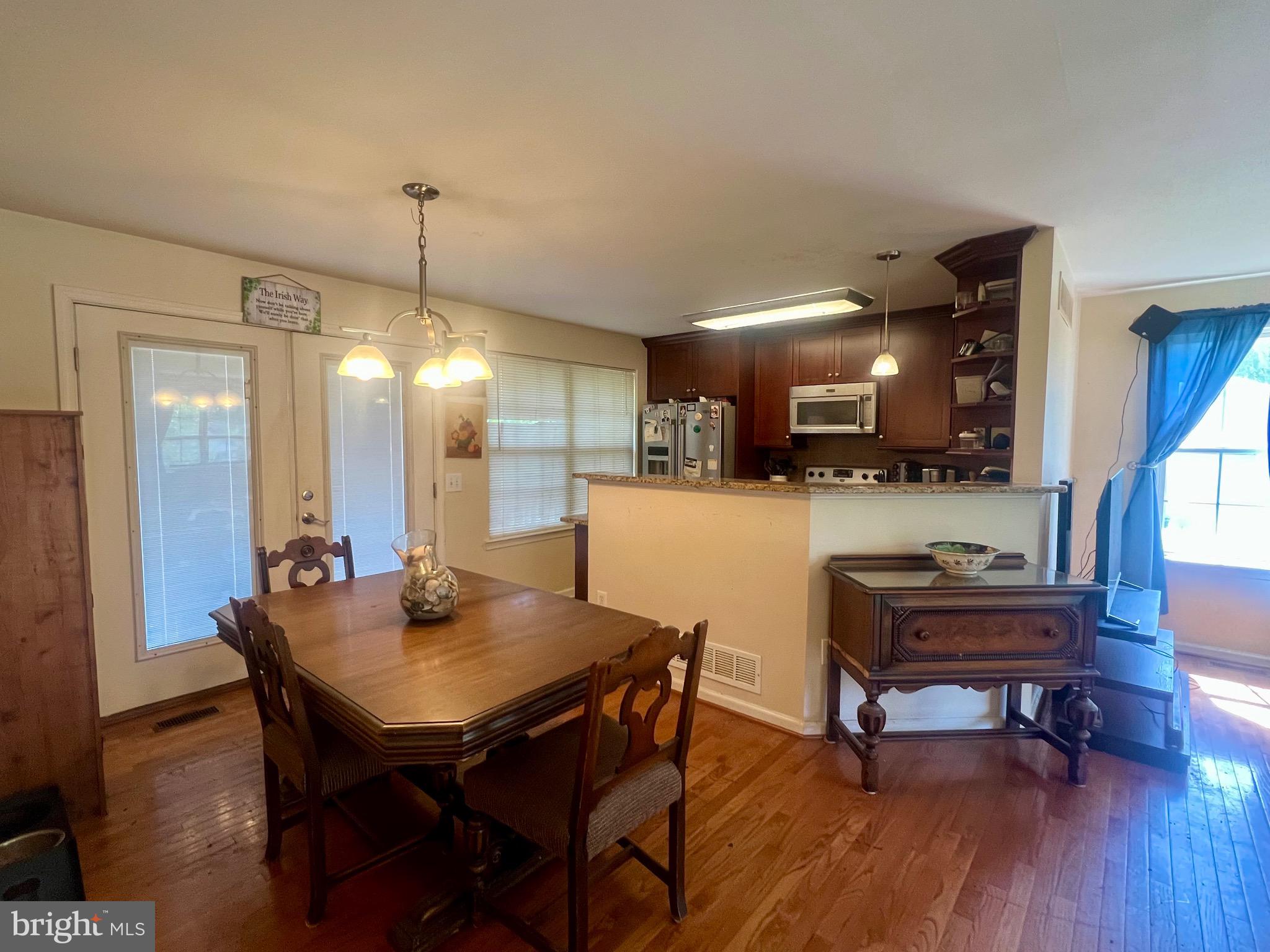103 Henson Road Glen Burnie, MD 21060 - Photo 13 of 29 a view of a dining room with furniture and wooden floor