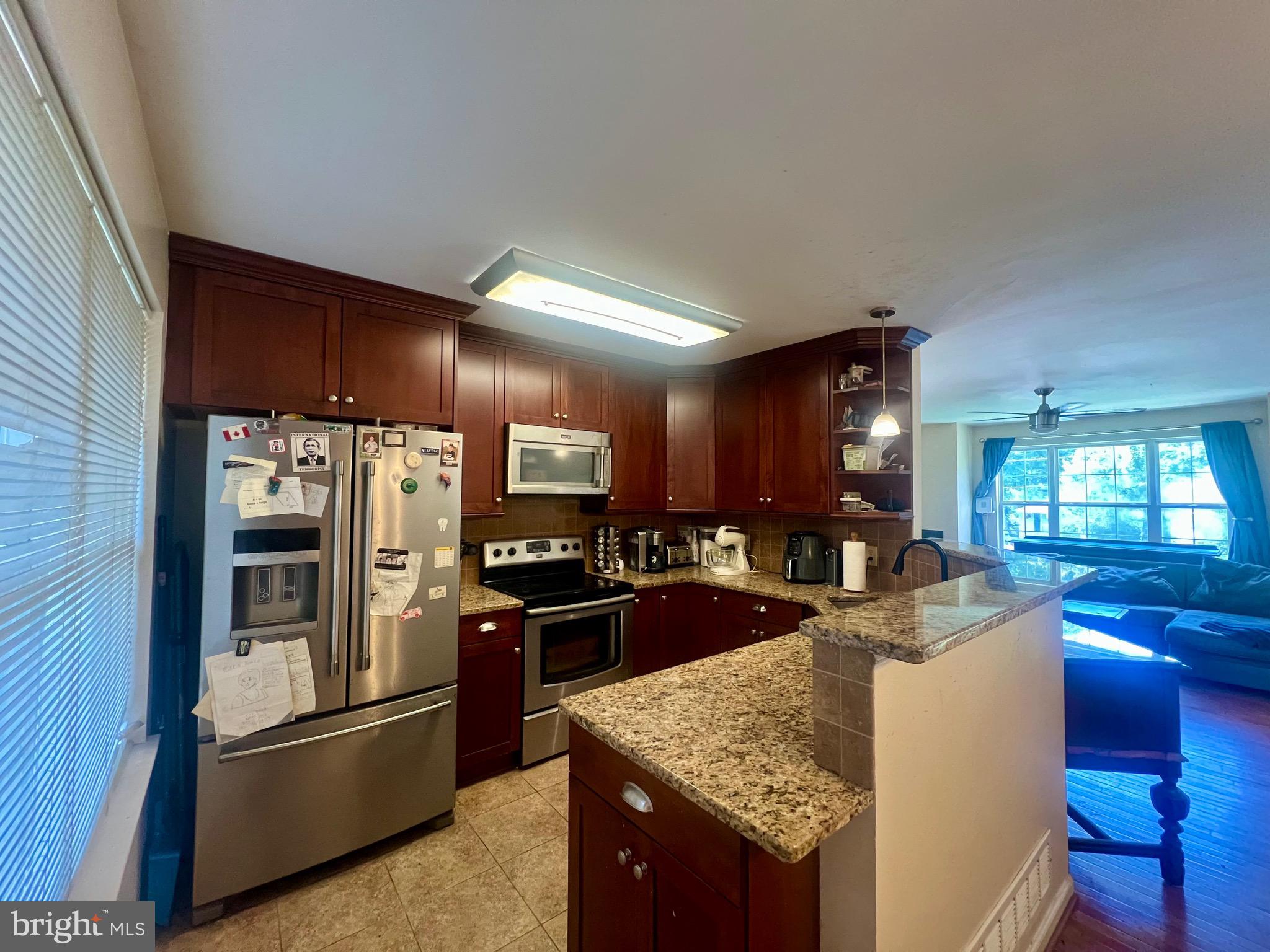 103 Henson Road Glen Burnie, MD 21060 - Photo 16 of 29 a kitchen with stainless steel appliances granite countertop a sink stove and refrigerator
