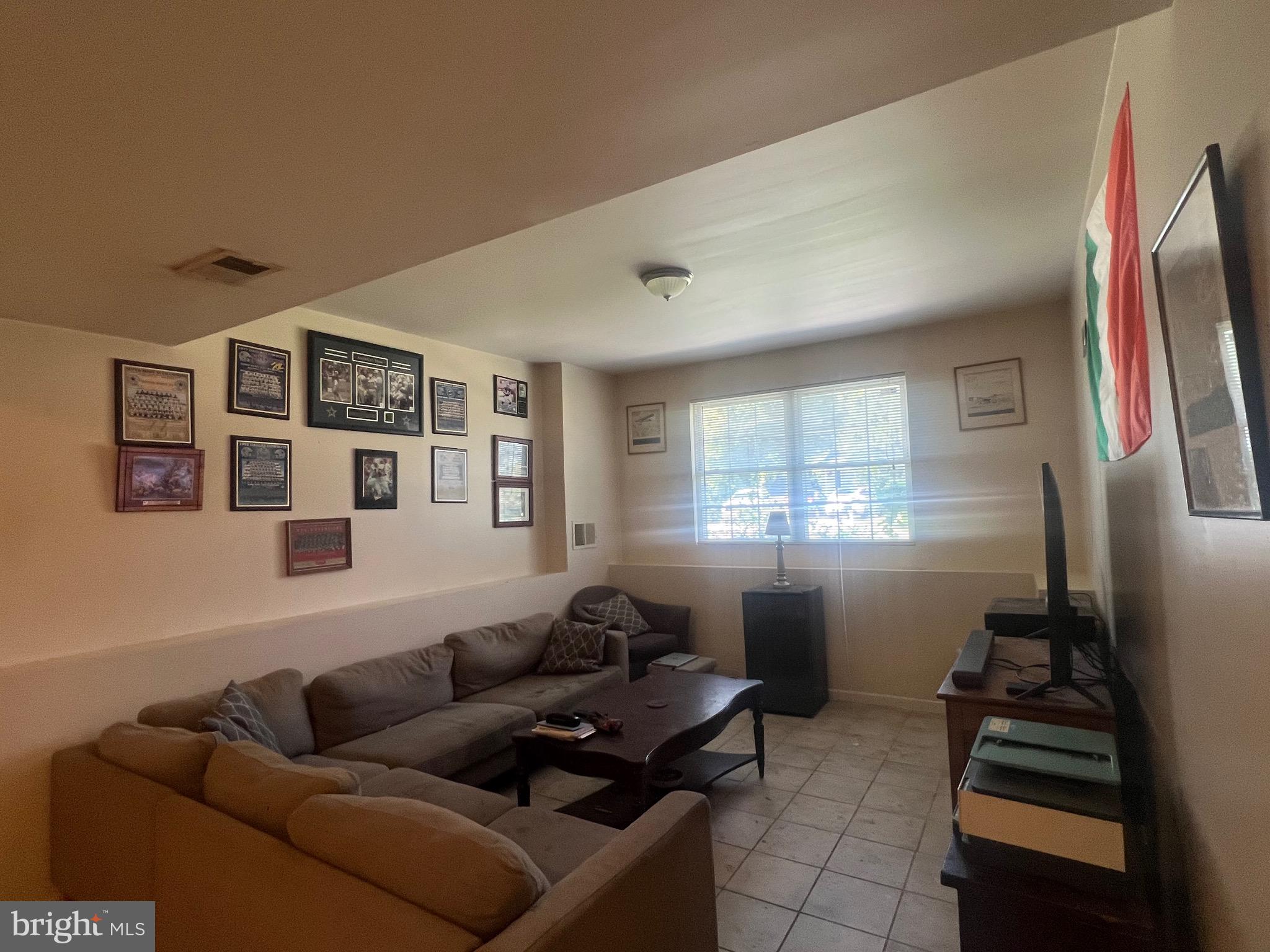 103 Henson Road Glen Burnie, MD 21060 - Photo 19 of 29 a living room with furniture a flat screen tv and a window