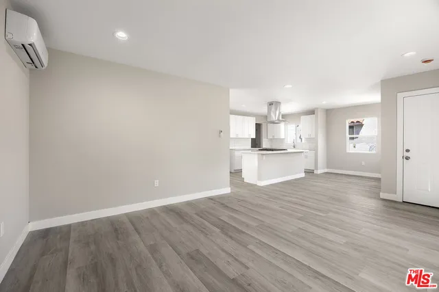 a view of a kitchen with a sink and a refrigerator