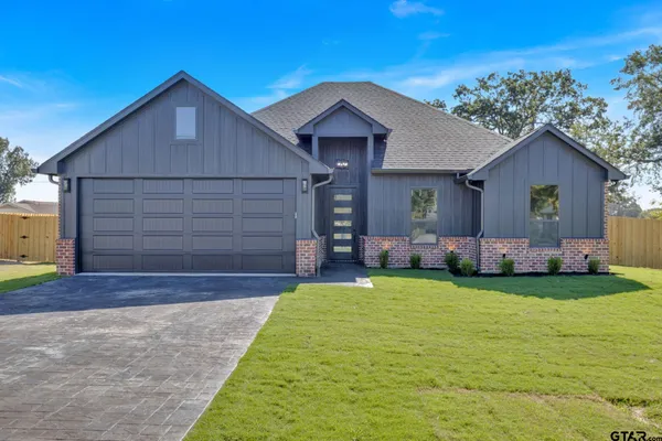a front view of house with yard and outdoor seating