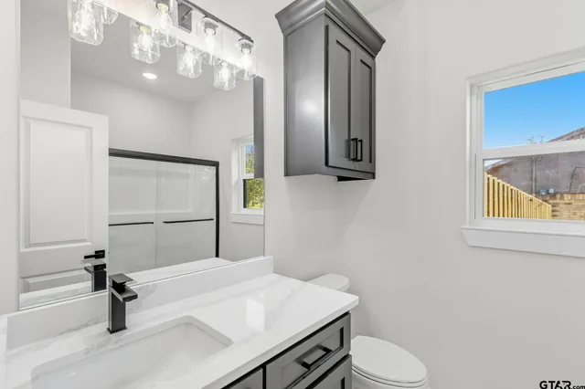 a view of a livingroom with a ceiling fan and window