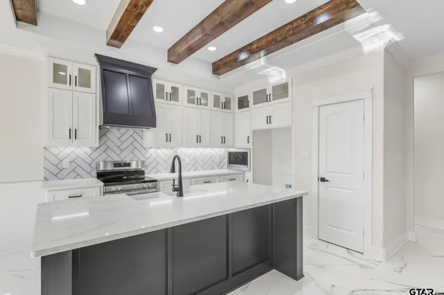 a bathroom with double vanity and a mirror