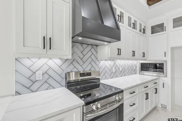 a kitchen with cabinets and appliances