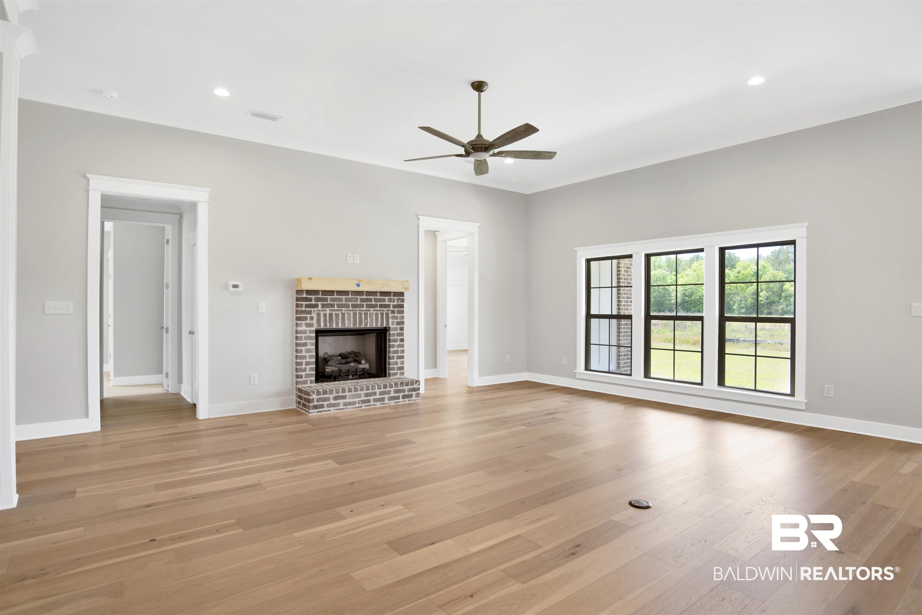 27331 Patch Pl Loop Daphne, AL 36526 - Photo 21 of 62 Unfurnished living room with a fireplace, ceiling fan, light wood-style floors, and recessed lighting