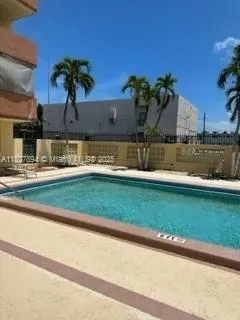 a front view of a house with a yard and palm trees