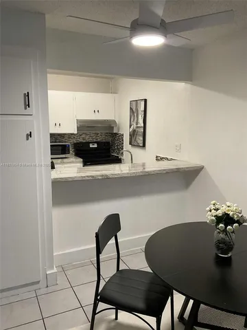 a kitchen with a table chairs and a stove