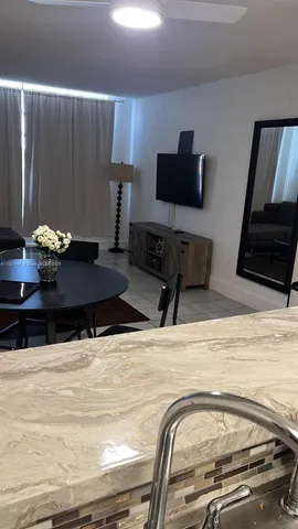 a view of kitchen with furniture and flat screen tv