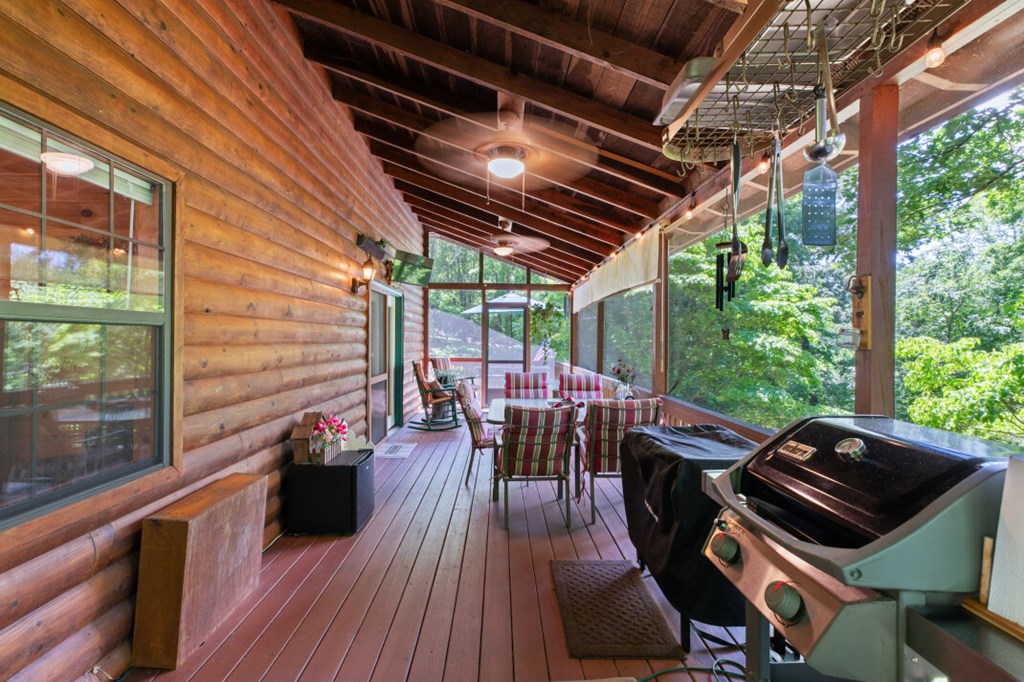 66 Fortenberry Road Young Harris, GA 30582 - Photo 31 of 55 a view of a patio with table and chairs and wooden floor