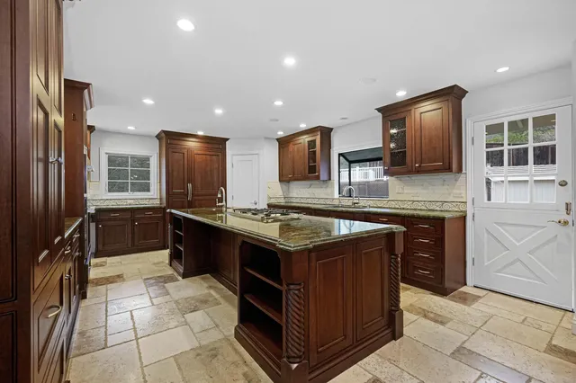 a large white kitchen with a large window