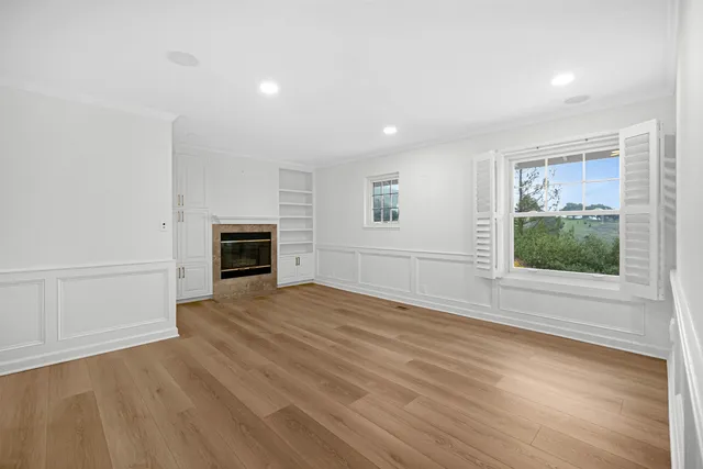 a view of balcony with wooden floor and fence