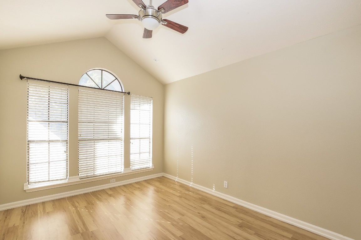 2802 Hummingbird Circle Cedar Park, TX 78613 - Photo 13 of 15 an empty room with wooden floor fan and windows