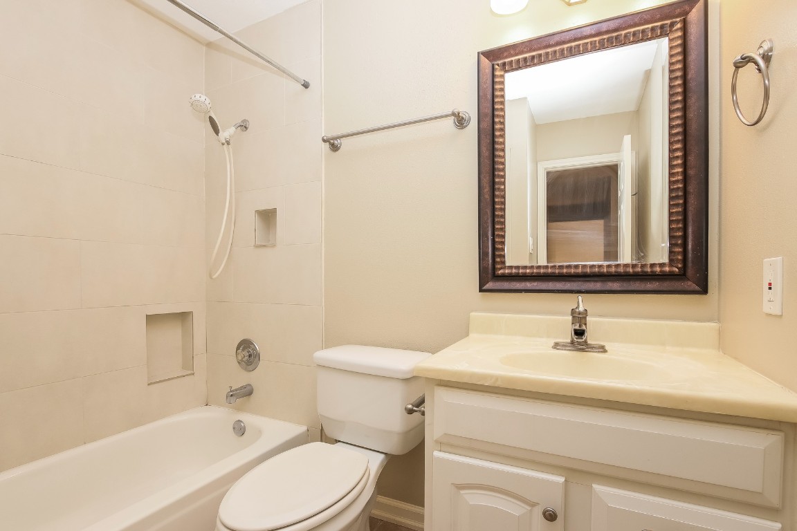2802 Hummingbird Circle Cedar Park, TX 78613 - Photo 14 of 15 a bathroom with a sink toilet a mirror and shower