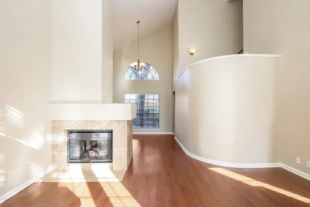 a view of a room with wooden floor and fireplace