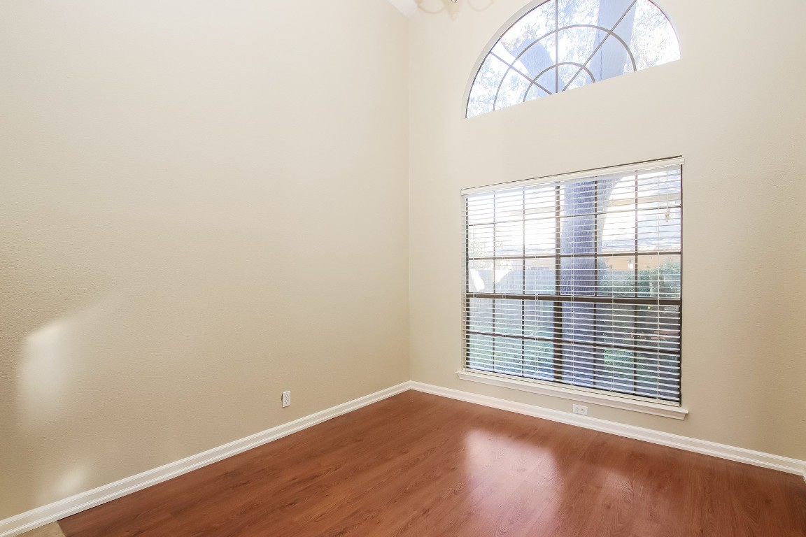 2802 Hummingbird Circle Cedar Park, TX 78613 - Photo 4 of 15 an empty room with wooden floor fan and windows