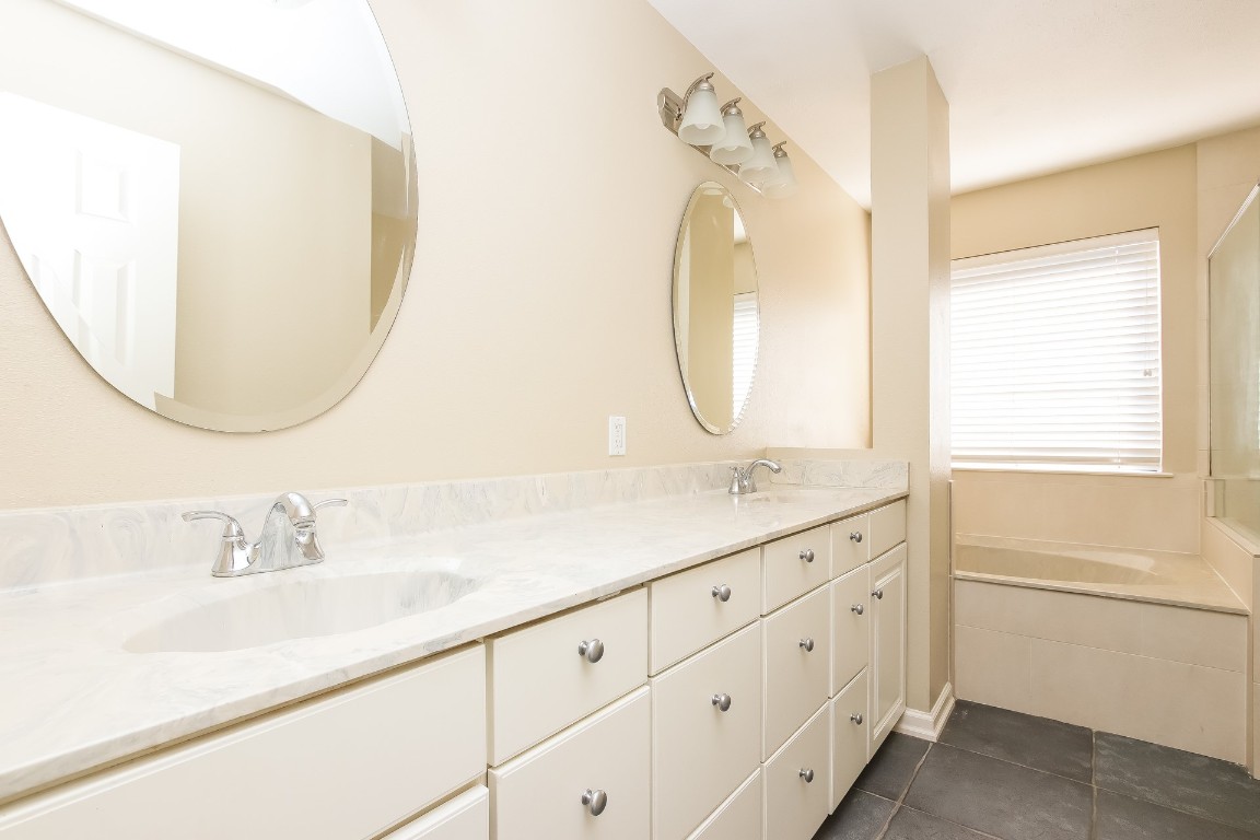 2802 Hummingbird Circle Cedar Park, TX 78613 - Photo 9 of 15 a bathroom with a sink vanity and a mirror
