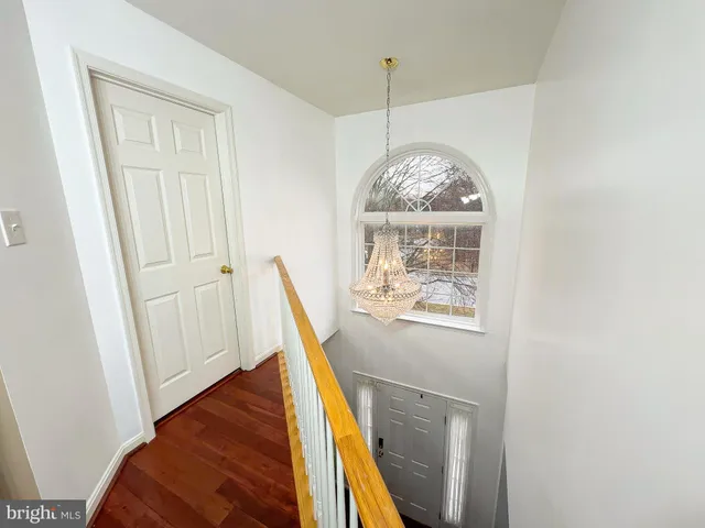 a view of a livingroom with wooden floor and entrance