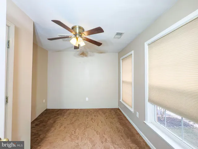 a view of an empty room and a window