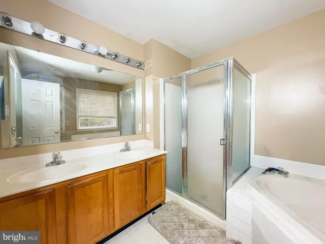 a bathroom with a tub sink and mirror