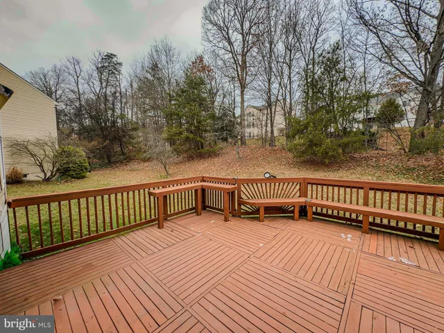a view of balcony with wooden floor and fence
