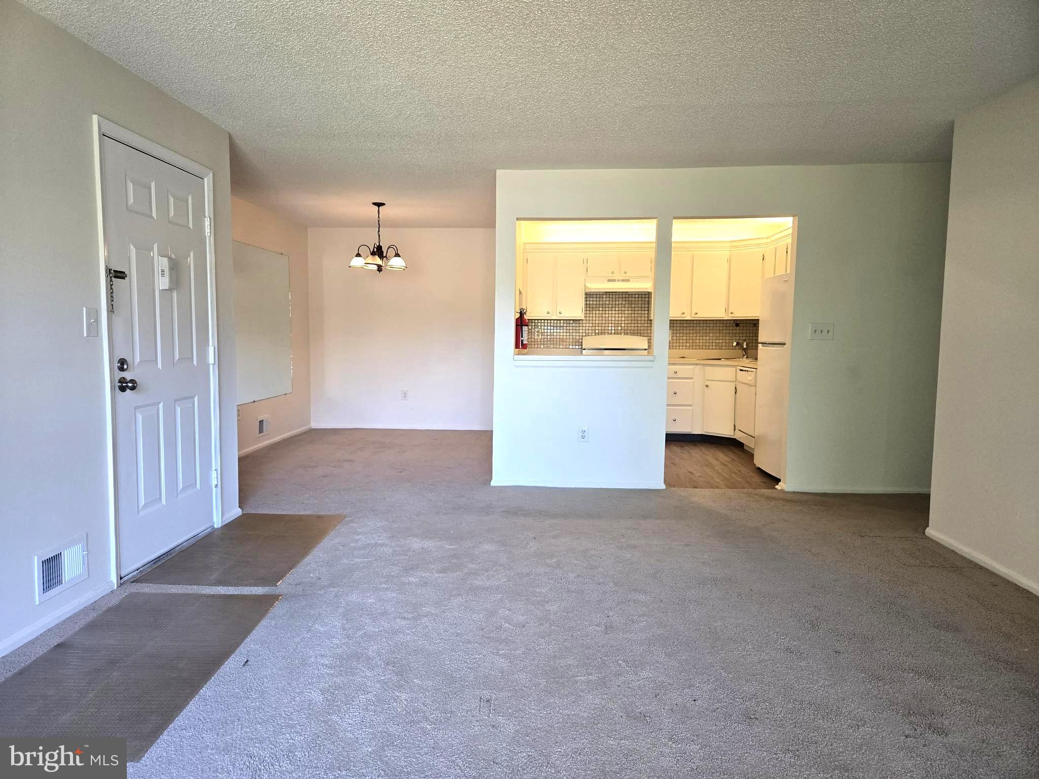 13 Voscek Court Lawrence Township, NJ 08648 - Photo 4 of 13 an empty room with a window and a kitchen view