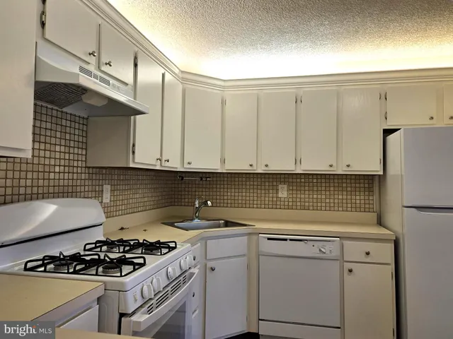 a kitchen with cabinets and appliances