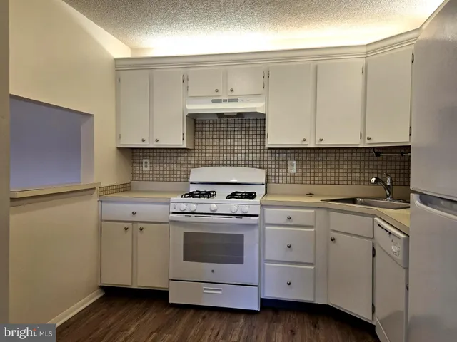a kitchen with cabinets appliances and a window