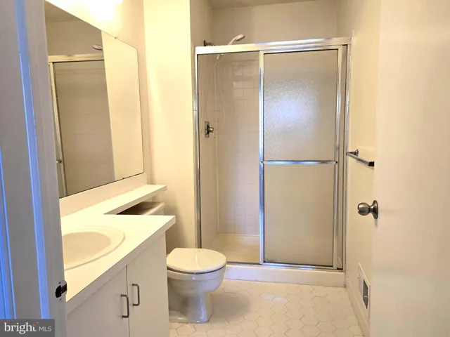 a bathroom with a toilet a sink and a shower