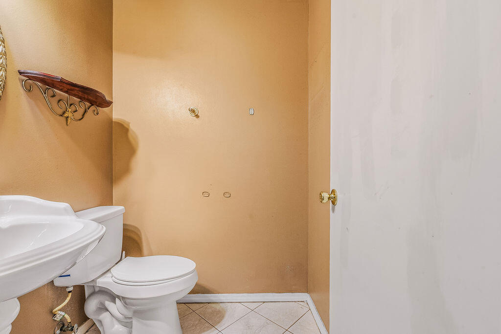53 4th Street Shalimar, FL 32579 - Photo 32 of 47 a white toilet sitting next to a small bathroom