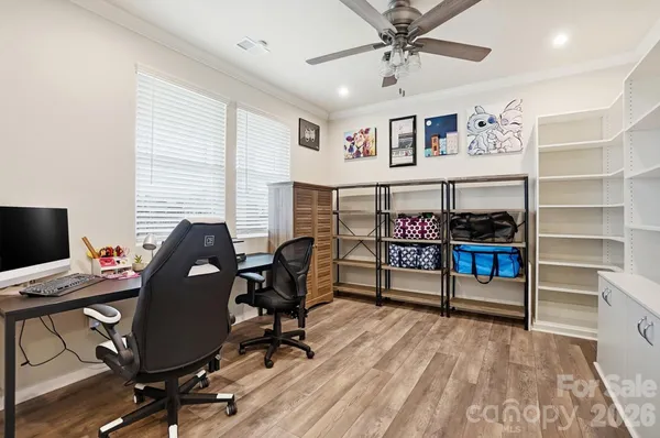 a view of a workspace with furniture and a window