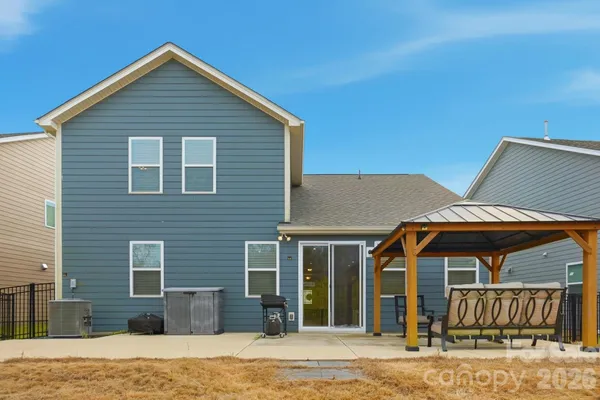 a view of a house with backyard porch and sitting area