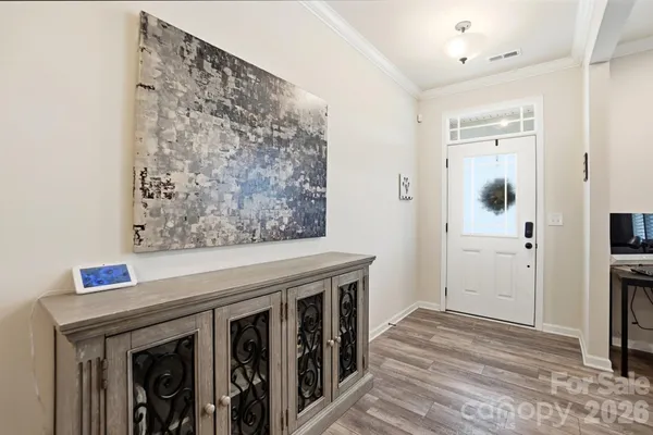 a view of a hallway with wooden floor and entryway