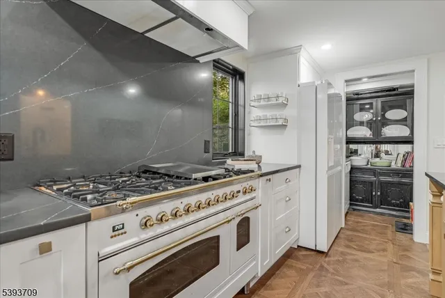 a living room with furniture a flat screen tv and a large window