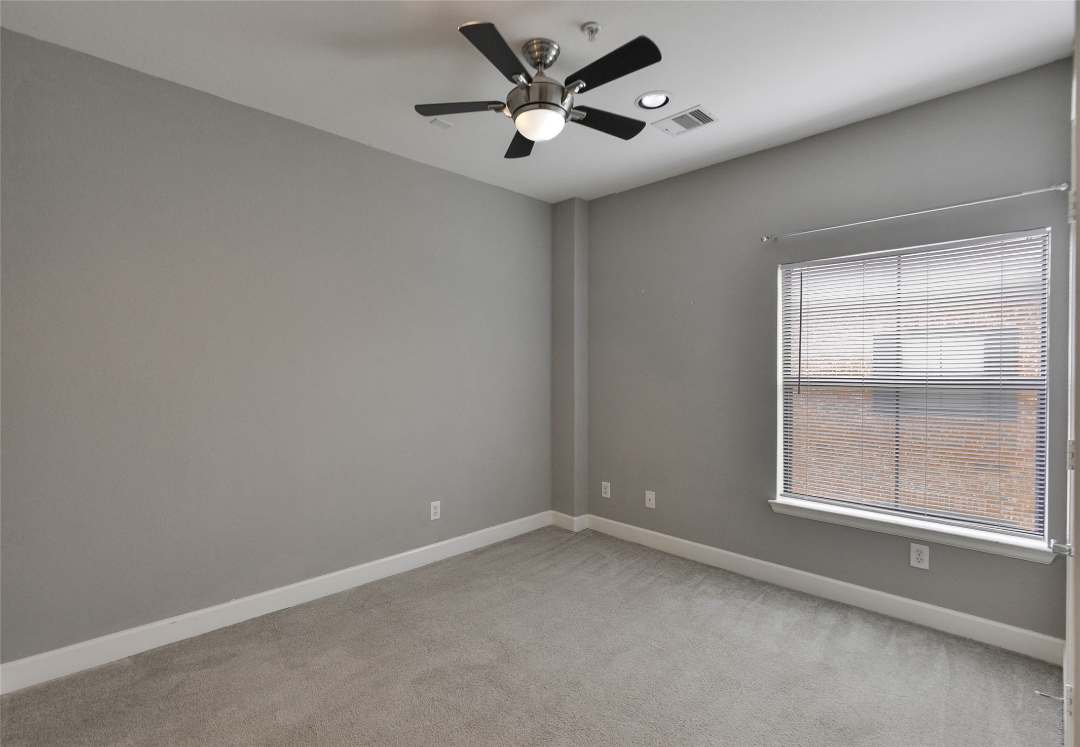 2904 Chenevert Street, Unit M Houston, TX 77004 - Photo 12 of 15 an empty room with a window and a fan