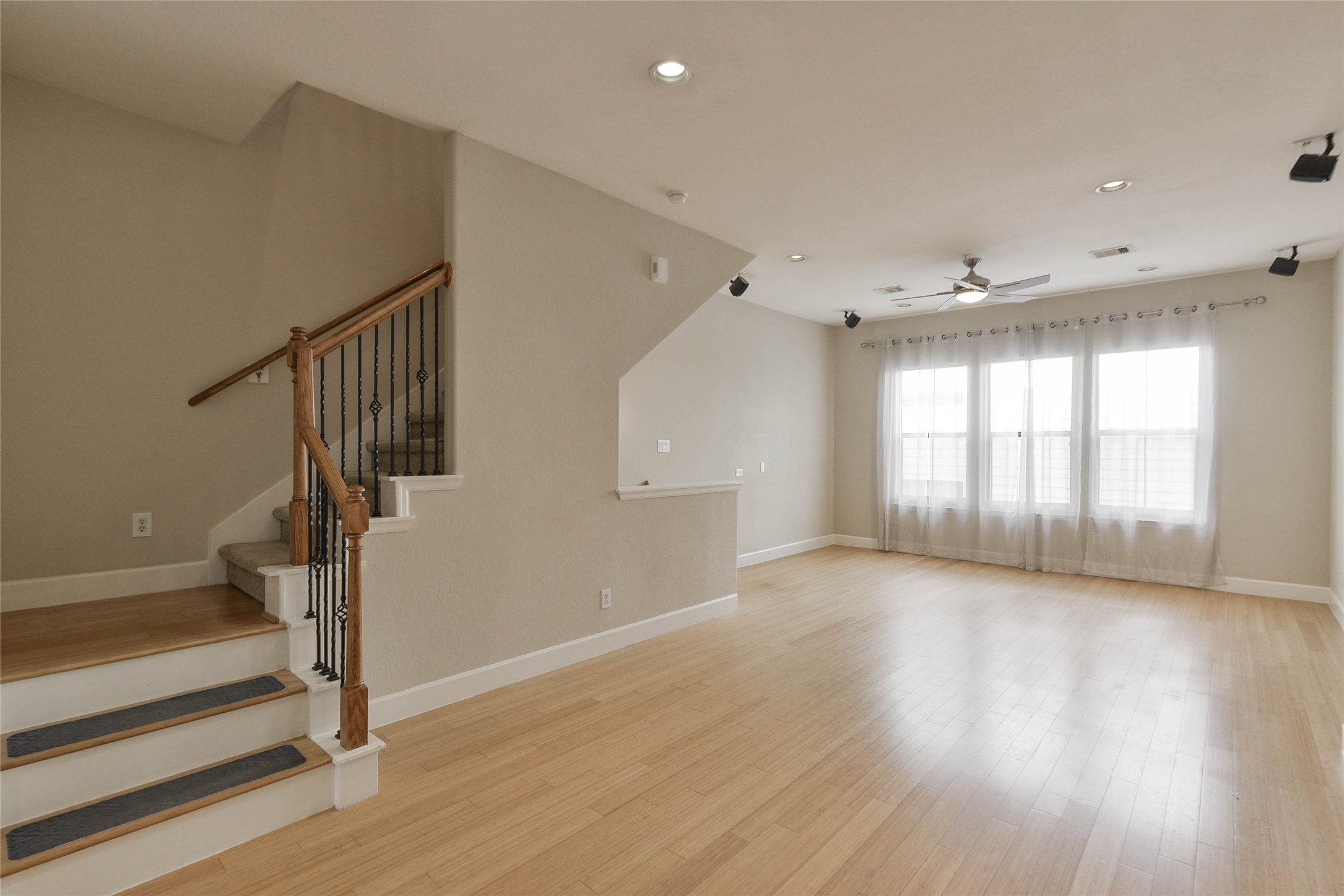 2904 Chenevert Street, Unit M Houston, TX 77004 - Photo 8 of 15 a view of an empty room with wooden floor and a window