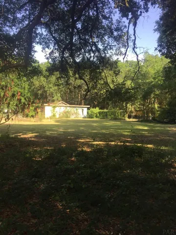 a view of a big yard with an outdoor space