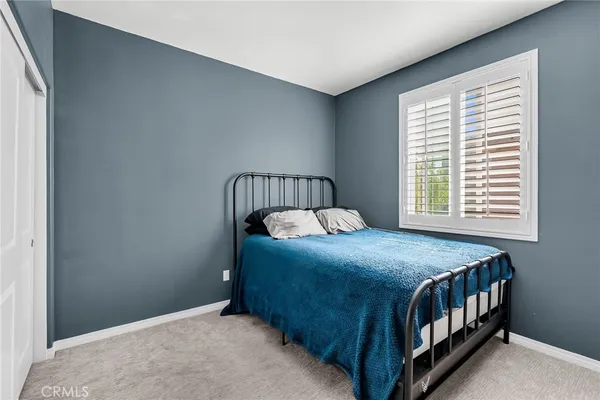 a bedroom with a bed and window