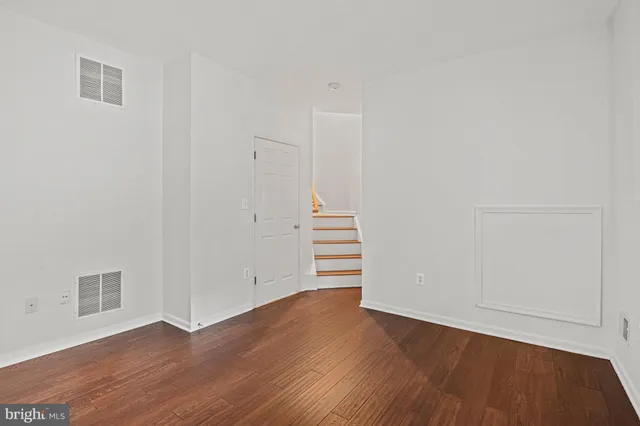 an empty room with wooden floor
