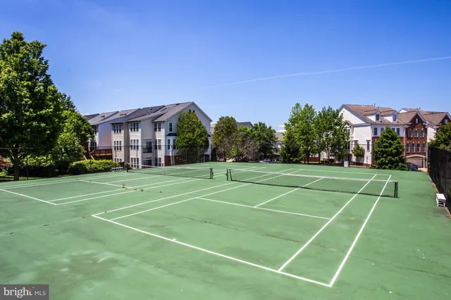 a front view of a house with yard and green space