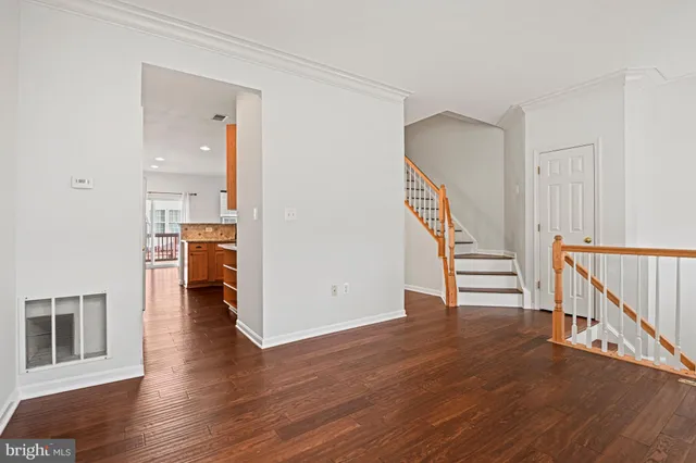 a view of entryway with wooden floor and stairs