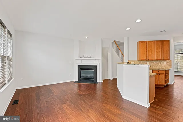 a view of a kitchen with a sink cabinet and a fireplace